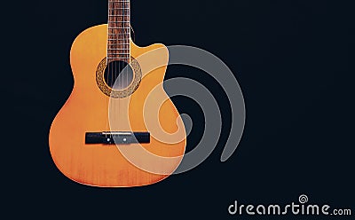 Six-string acoustic guitar on a dark brown background. Classical Spanish guitar. Musical instrument. Place for text Stock Photo