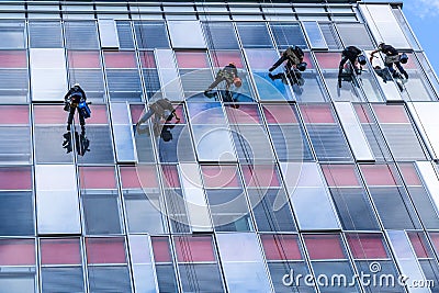 Six young men are cleaning windows Editorial Stock Photo