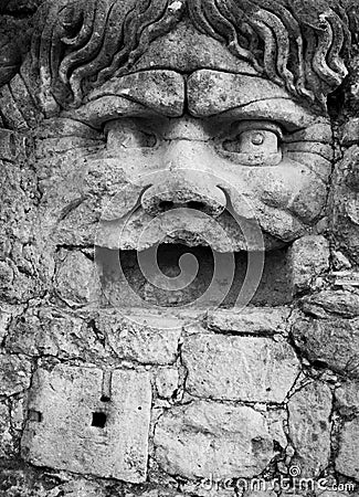 Sixteenth century era statue of a man with open mouth and curly hair Stock Photo