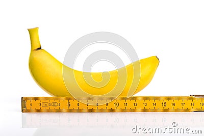 Size matters concept, banana with ruler isolated on white Stock Photo