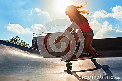 Young woman riding on surf skate Stock Photo