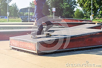A skateboarder in action doing tricks on ramps at a skate park Stock Photo