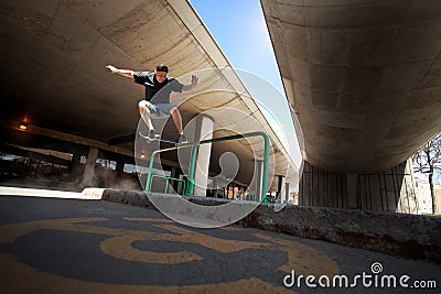 Skateboarder doing a Crooked Grind trick on a Rail Stock Photo