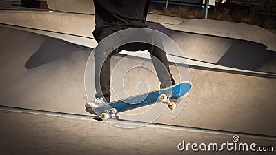 Skateboarder grinding in skate-park Stock Photo