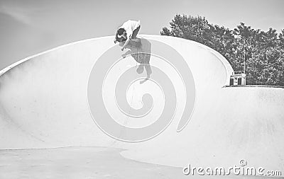 Skater performing in skate park ramp - Young man riding skateboard in urban spot - Extreme sport, youth and trendy z generation Editorial Stock Photo