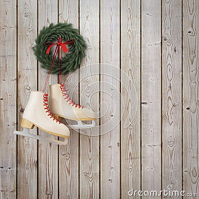 Skates hanging on the wooden planks wall with garland, winter Christmas background Stock Photo