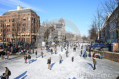 Skating over dutch canal in Amsterdam Editorial Stock Photo