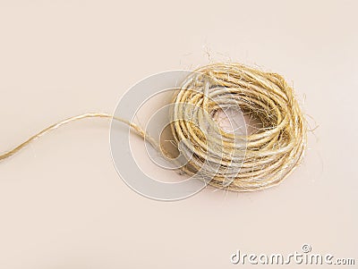 Skein of jute twine isolated on light beige natural background Stock Photo