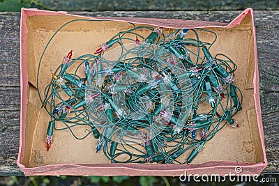 A skein of an old green electric Christmas garland with small colored light bulbs Stock Photo
