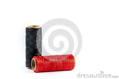 A skein of red and black thread. Coils of colored threads on a white background. Waxed sewing thread for leather goods. Stock Photo