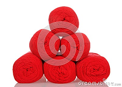 Skeins of red yarn stacked in a pyramid isolated on white Stock Photo