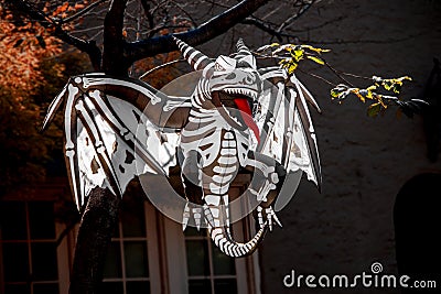 Skeleton Demon Dragon blowup Halloween yard art - hanging from tree - long red tongue - evil Stock Photo