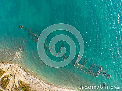 Skeleton of a destroyed seagoing ship near the shore Stock Photo