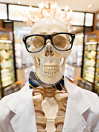 Skeleton in doctors smock with glasses and bow tie Stock Photo