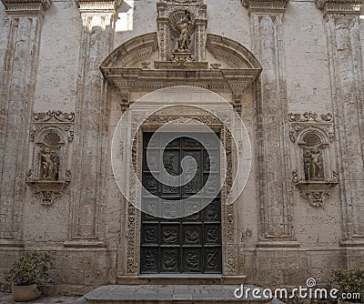 The skeleton entrance door of the church Fraternal Organization of our Lady of Suffrage in Monopoli, Italy Stock Photo