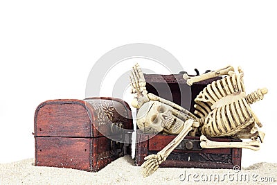 Skeleton in a treasure chest on pile sand isolated on white back Stock Photo