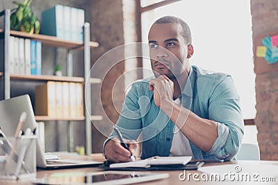 Skeptic, unsure, uncertain, doubts concept. Young african student is making decision sitting at the office in casual smart Stock Photo