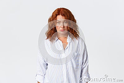Skeptical and confused, tired redhead middle-aged female employee, entrepreneur looking exhausted and puzzled, cant Stock Photo