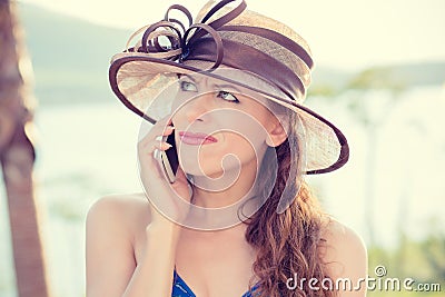 Skeptical woman talking on phone deciding what to answer Stock Photo