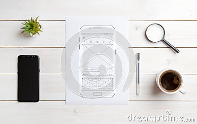 Sketch of mobile app on paper. Top view scene of web designer desk Stock Photo