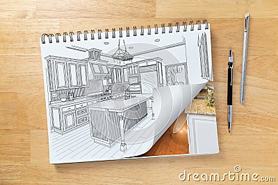 Sketch Pad on Desk with Drawing of Kitchen and Page Turning to Show Finished Construction Next To Pencil, Ruler Stock Photo