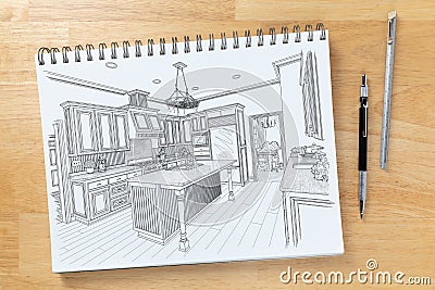 Sketch Pad on Desk with Drawing of Custom Kitchen Interior Next To Engineering Pencil and Ruler Scale Stock Photo