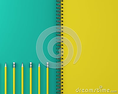 Sketchbook and yellow pastel pencil on green and yellow background. Top view , flat lay. Minimal work space. The concept of work Stock Photo