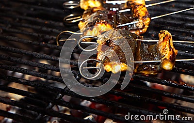 Skewered pieces of fresh Japanese marinated eel on the hot charcoal grill Stock Photo
