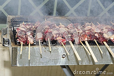 Skewers of meat on the grill Stock Photo