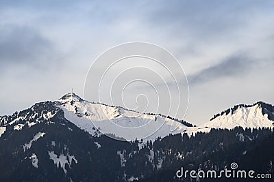 Ski area at the reuttener hahnenkamm in winter with gentle clouds Stock Photo