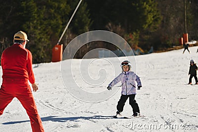 Ski coach giving a lesson to a child Stock Photo