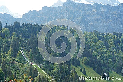 Ski jumping bridge on the slope of Alp mountains in Engelberg region, canton Obwalden in Switzerland in the springtime. Stock Photo