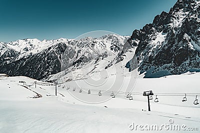 Ski lift in Almaty mountains. Shymbulak Ski Resort Hotel now-capped Tian Shan in Almaty city, Kazakhstan, Central Asia. Stock Photo