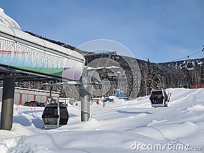 Ski lift with closed cabins. Ascent to the mountains by funicular Stock Photo