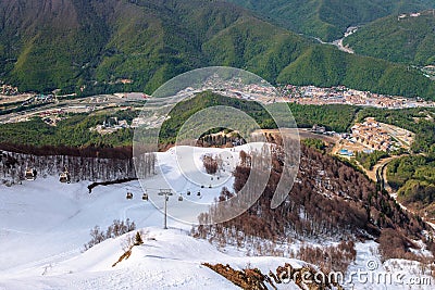 Ski lift of Gorky Gorod mountain ski resort at spring. Sochi, Russia. Scenic landscape Stock Photo