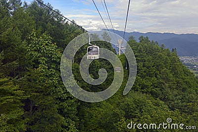 Ski lift in the mountains carrying passengers to hiking trail Stock Photo