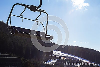 ski lift at a ski resort early in the morning illuminated by the sun. Stock Photo