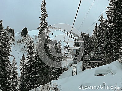 Ski lift, ski slopes and snow-capped mountains in Hoch-Ybrig, Switzerland. Stock Photo