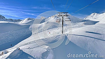Ski lift and ski slopes in beautiful snowy mountains Stock Photo