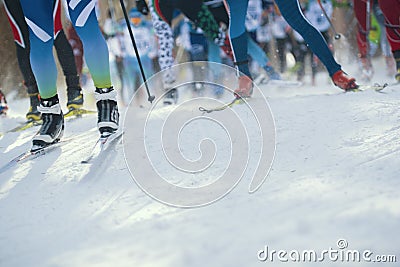 Ski marathon - de-focused view of many legs of sportsmen running on snow Stock Photo