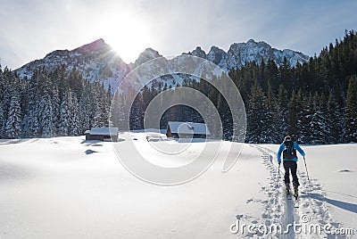 Ski mountaineer reaches alpine hut. Stock Photo