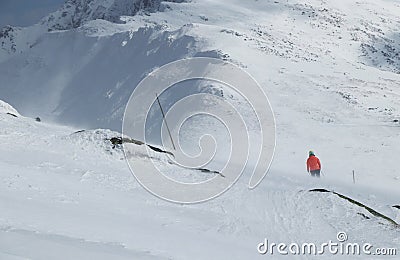 Ski resort in Low Tatras in Slovakia. Young female skier skiing and fight with huge wind from side. Ski resort Jasna Chopok, Stock Photo