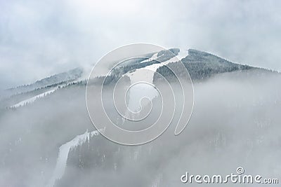 Ski slope mountain in fog, Medvedin resort, Czechia Stock Photo