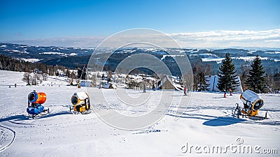 Ski slope with snow cannons in rural mountain area Editorial Stock Photo