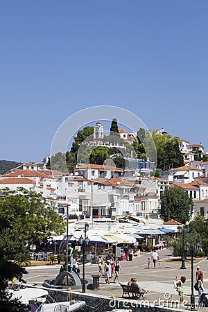 Agios Nikolaos Church and Clock Tower above harbour with Alexander Papadiamantis statue below Editorial Stock Photo