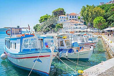 Quaint fishing and charter boats moored along old port waterfront Editorial Stock Photo