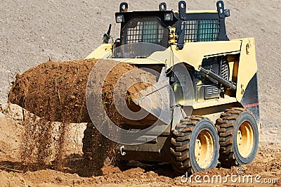 Skid steer loader at earth moving works Stock Photo