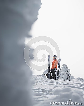 Skier in the backcountry of a snowy mountain landscape near Rossland Range, Canada Editorial Stock Photo
