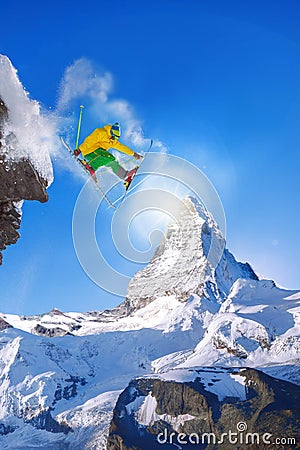 Skier jumping against Matterhorn peak in Switzerland. Stock Photo