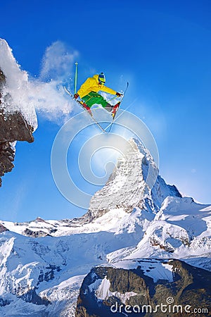 Skier jumping against Matterhorn peak in Switzerland. Stock Photo